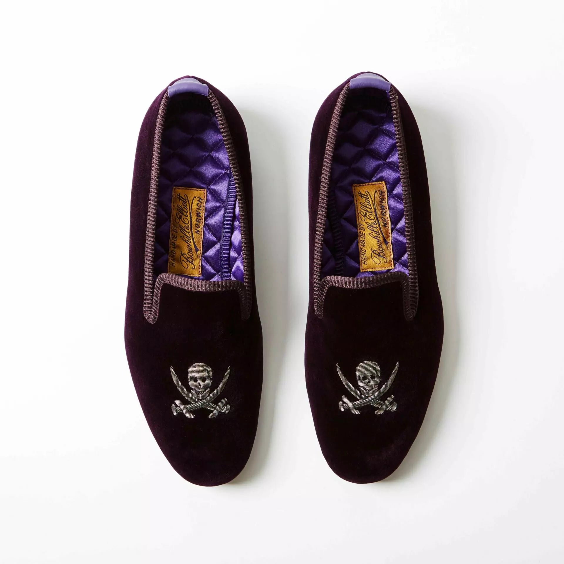 Purple Bowhill and Elliott velvet Albert slippers embroidered with skulls and crossed swords at Waring Tuxedos in Fort Worth.