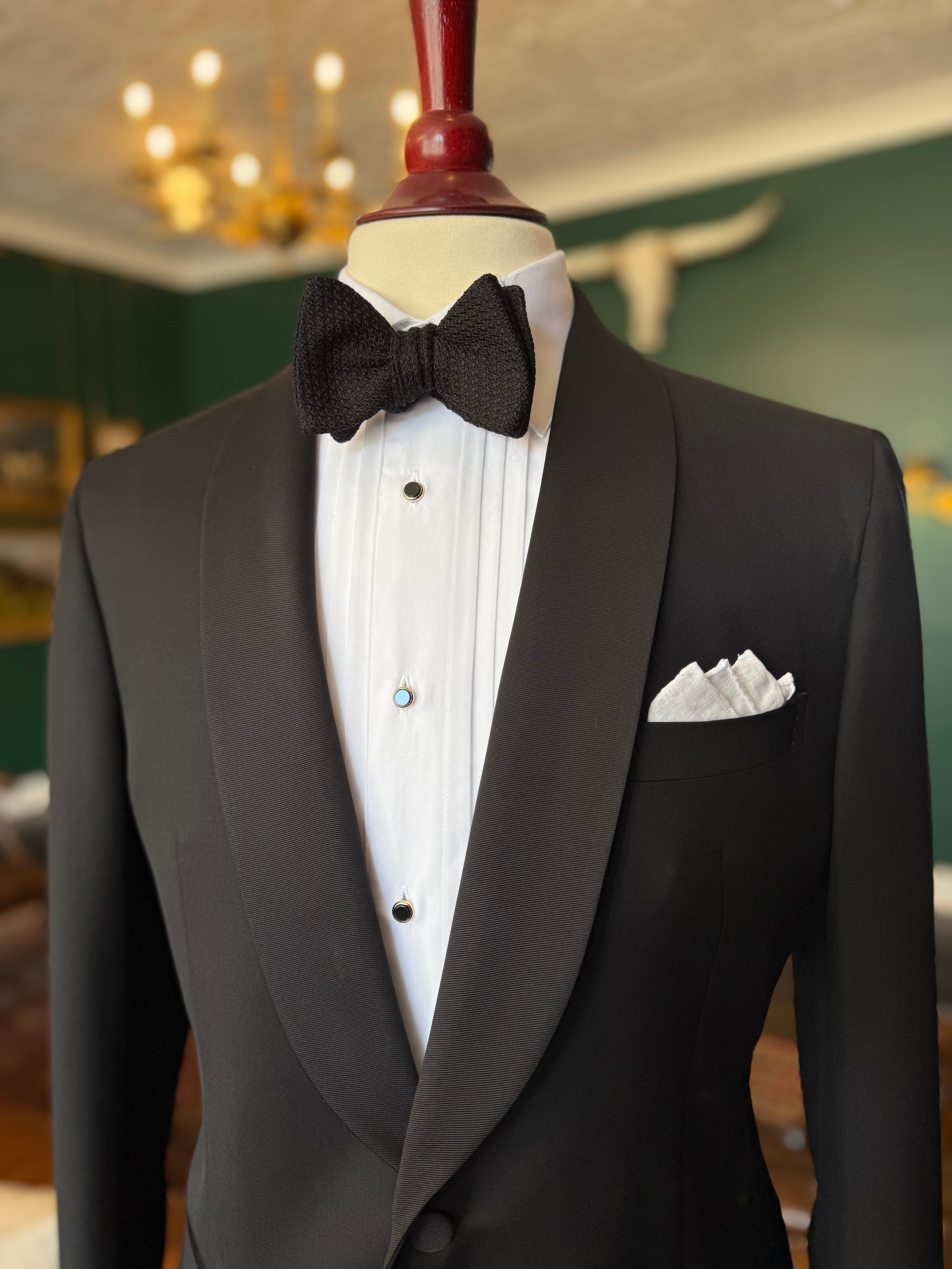 Classic grosgrain shawl lapel tuxedo at Waring Tuxedos in Fort Worth, displayed on a mahogany mannequin