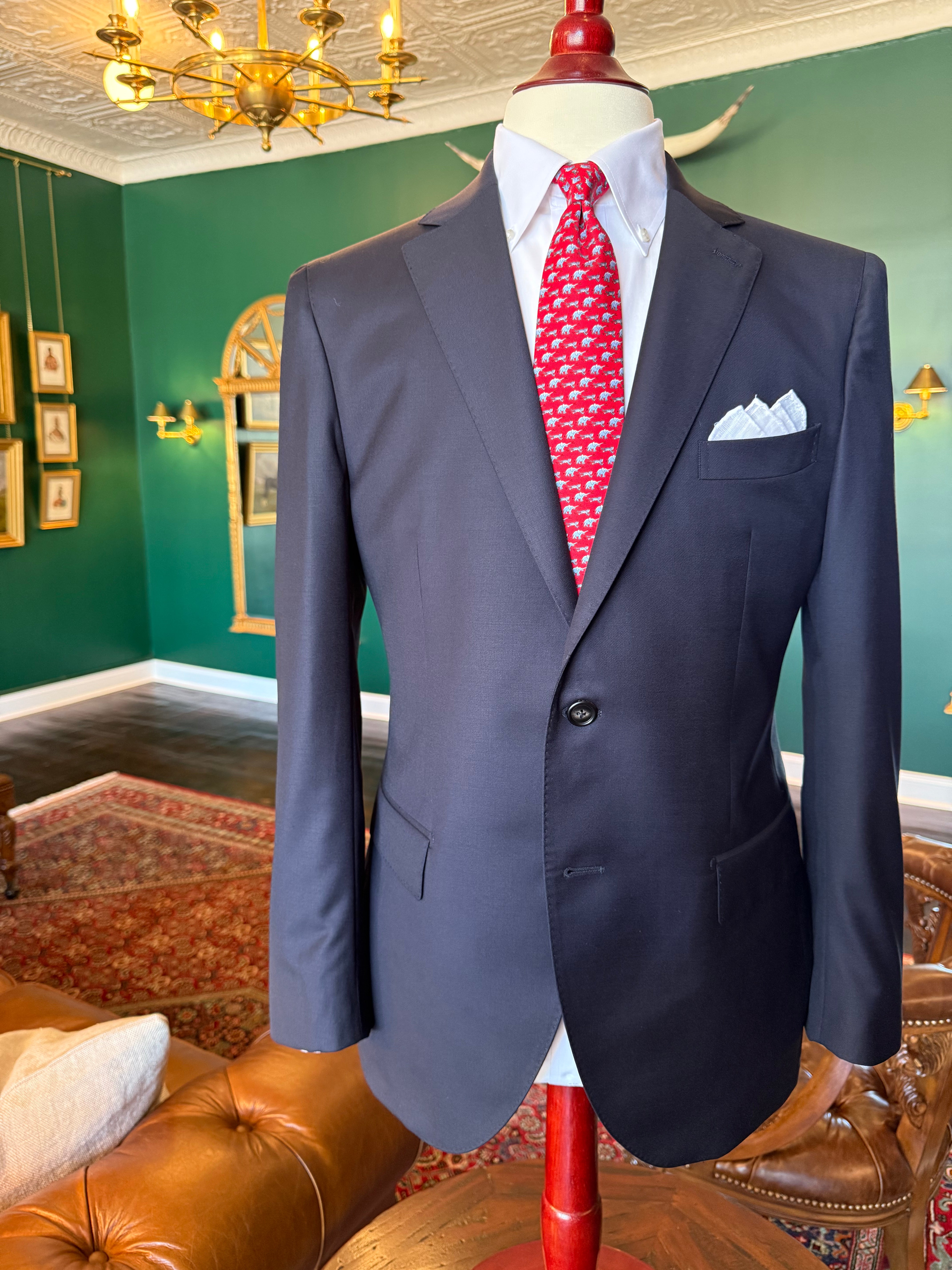 Classic navy suit displayed on a mahogany mannequin at Waring Tuxedos in Fort Worth.