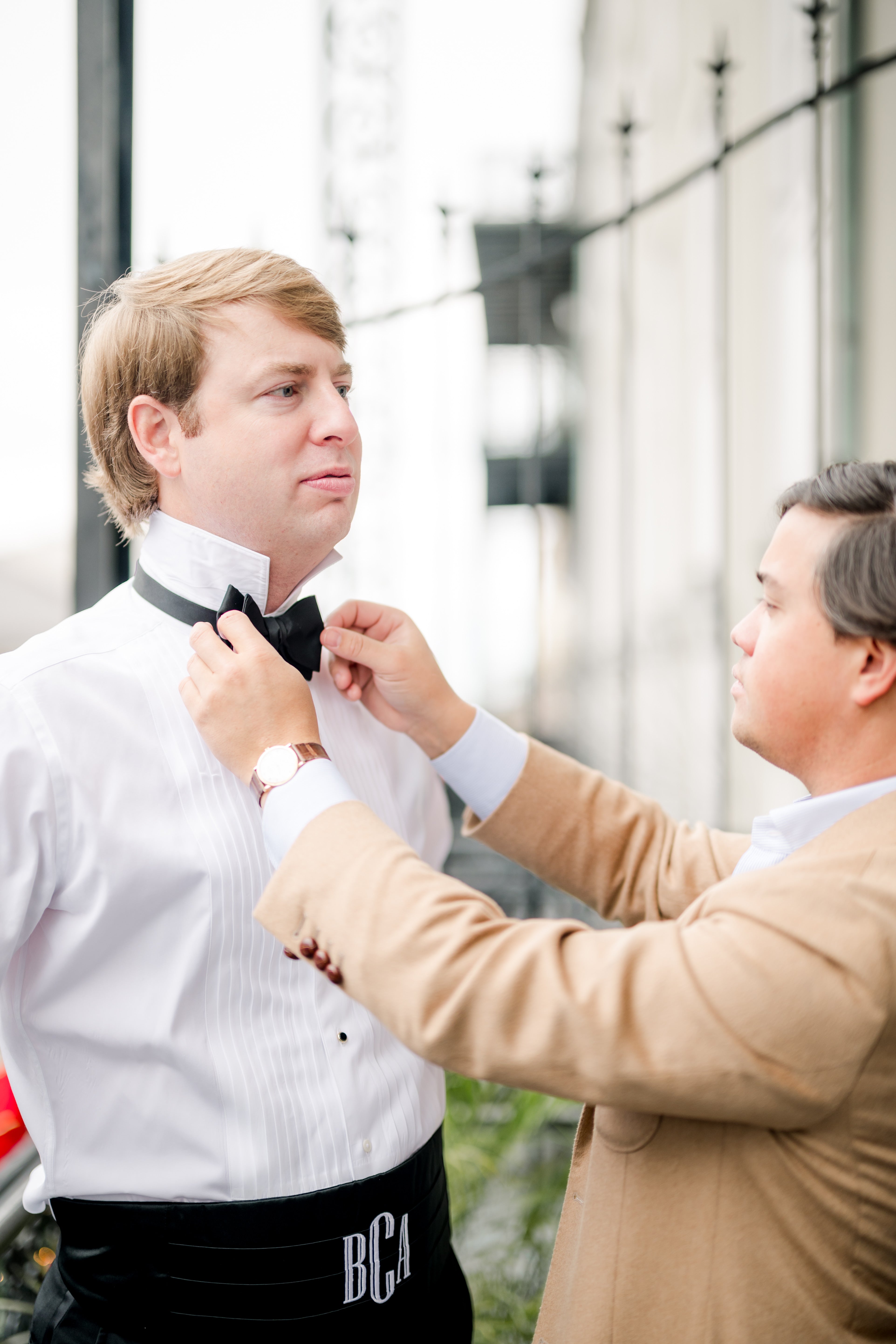 Houstoun Waring from Waring Tuxedos ties a groom's bow tie