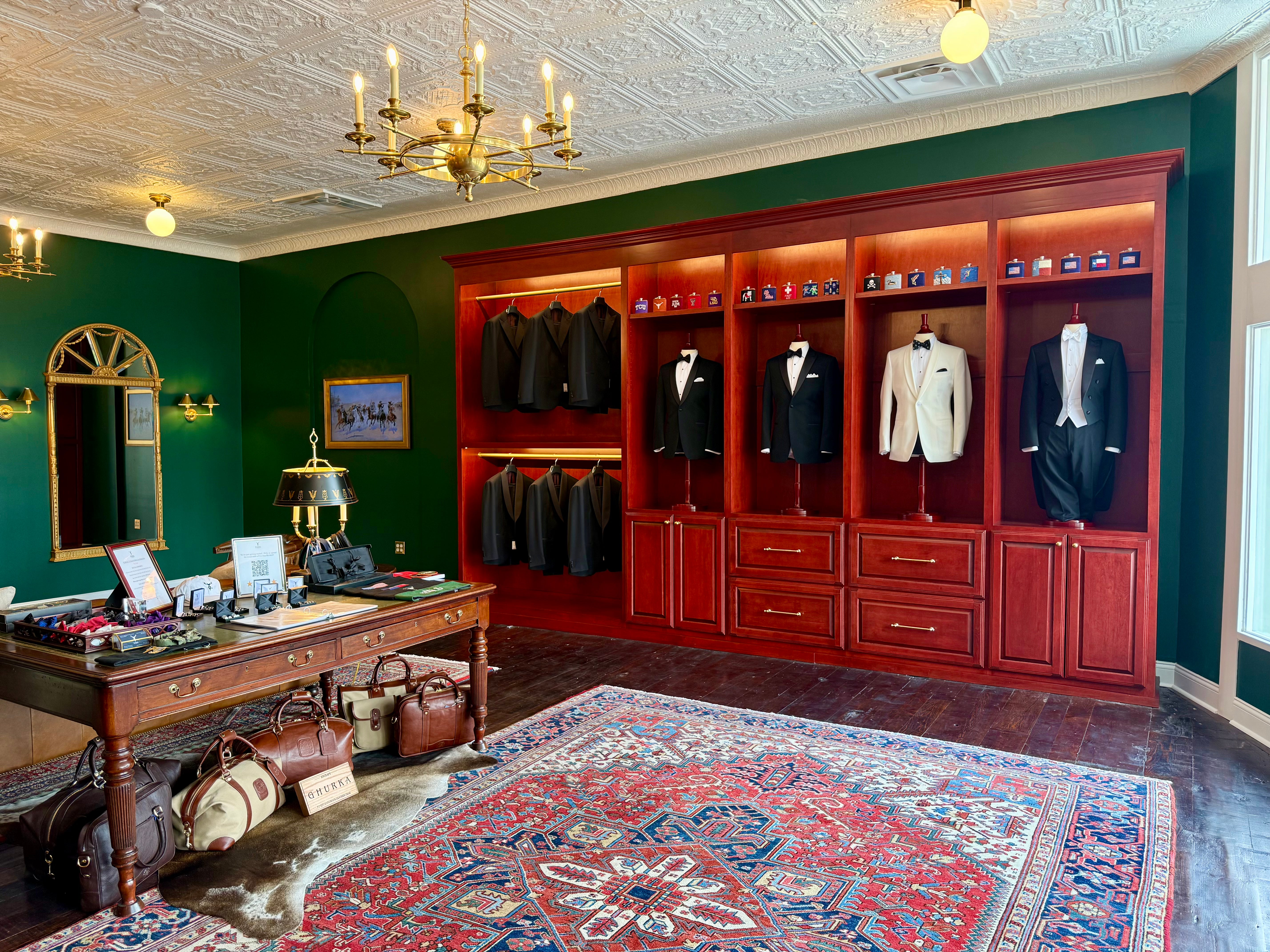 Waring Tuxedos rental tuxedo styles on mahogany mannequins against green wall in traditional tailor shop