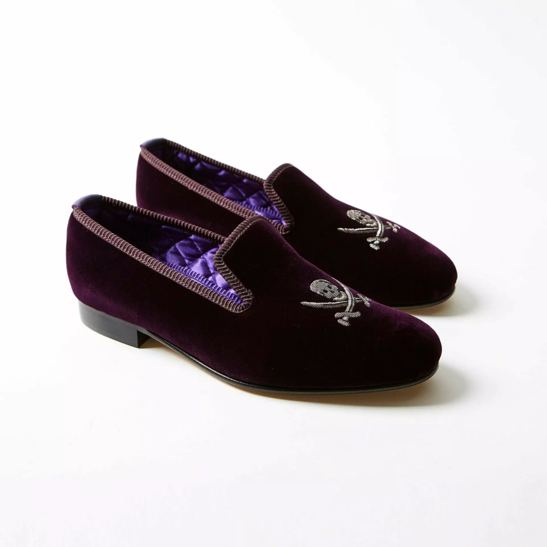 Purple Bowhill and Elliott velvet Albert slippers embroidered with skulls and crossed swords at Waring Tuxedos in Fort Worth.