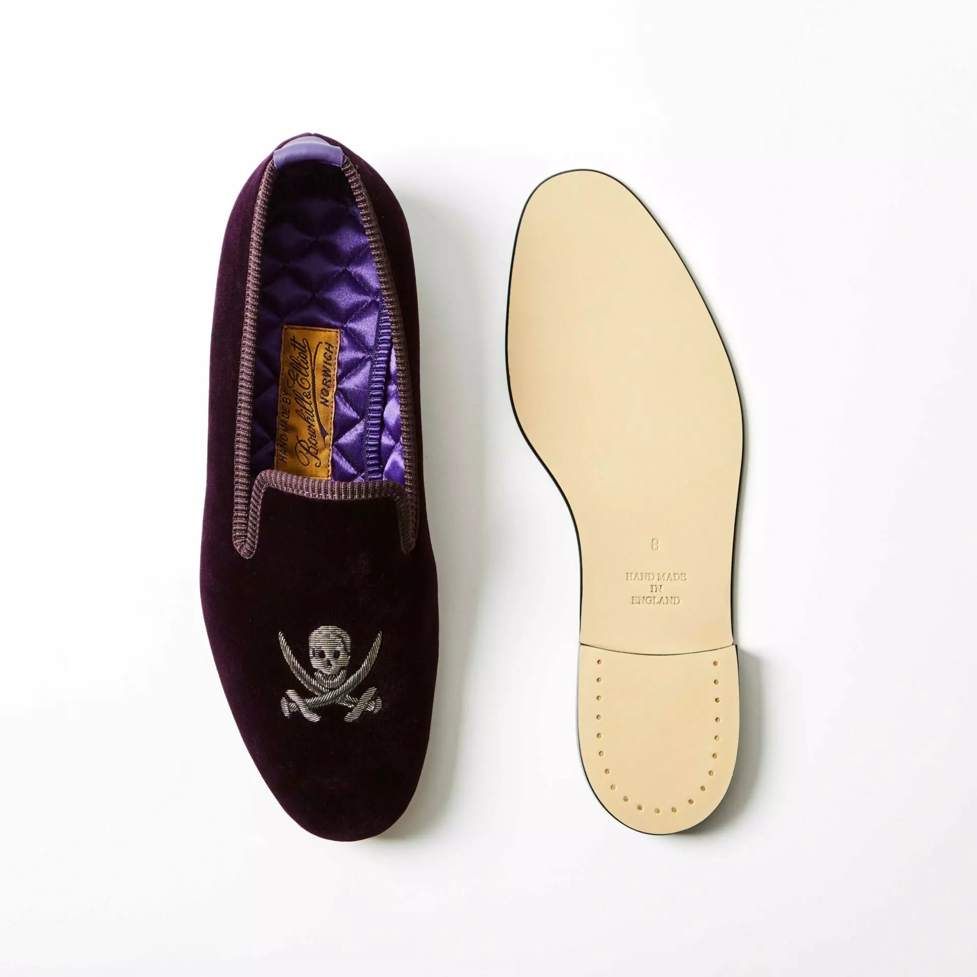 Purple Bowhill and Elliott velvet Albert slippers embroidered with skulls and crossed swords at Waring Tuxedos in Fort Worth.