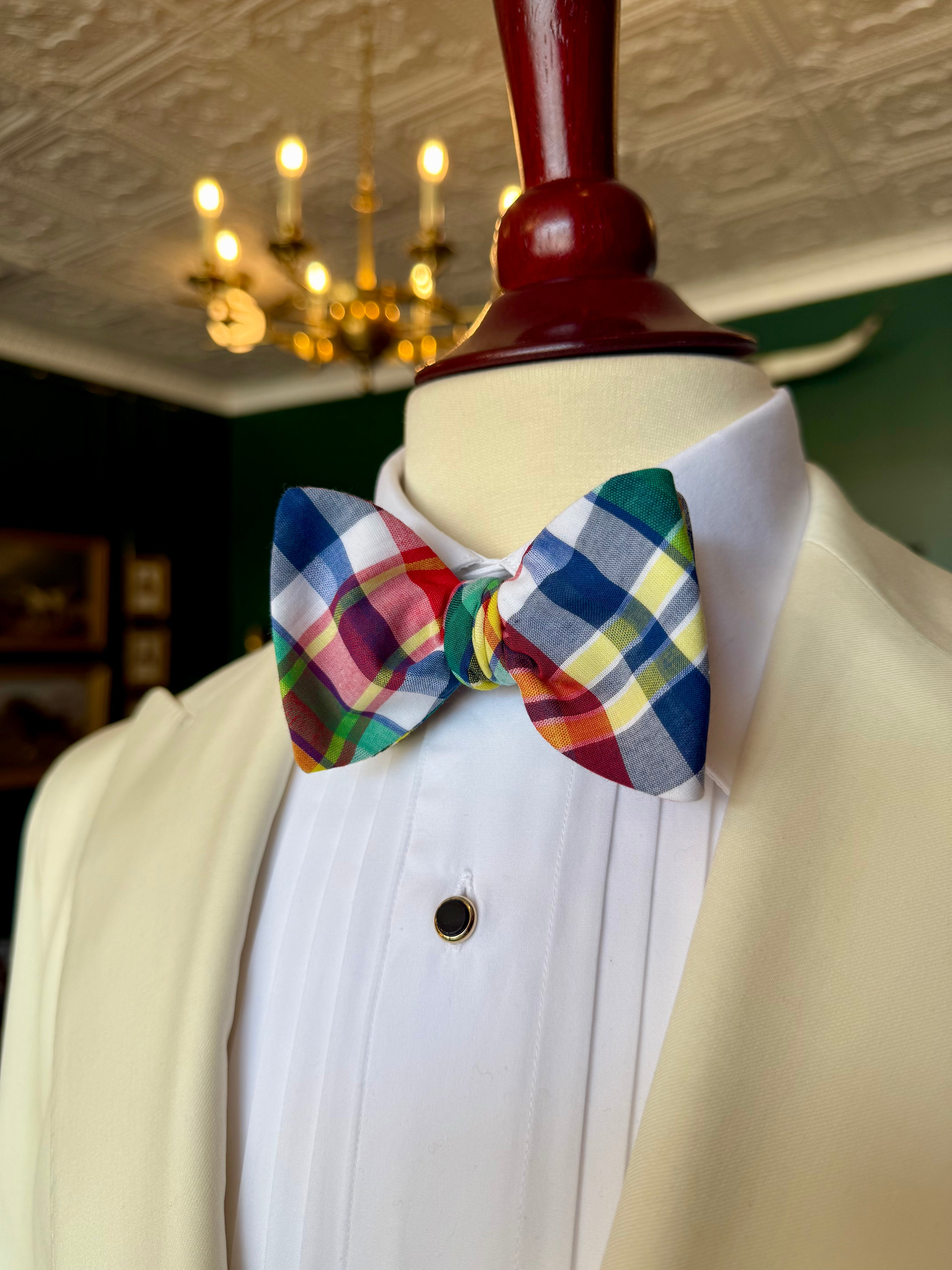 Madras Bow Tie from Waring Collection at Waring Tuxedos in Fort Worth, displayed on mahogany mannequin.