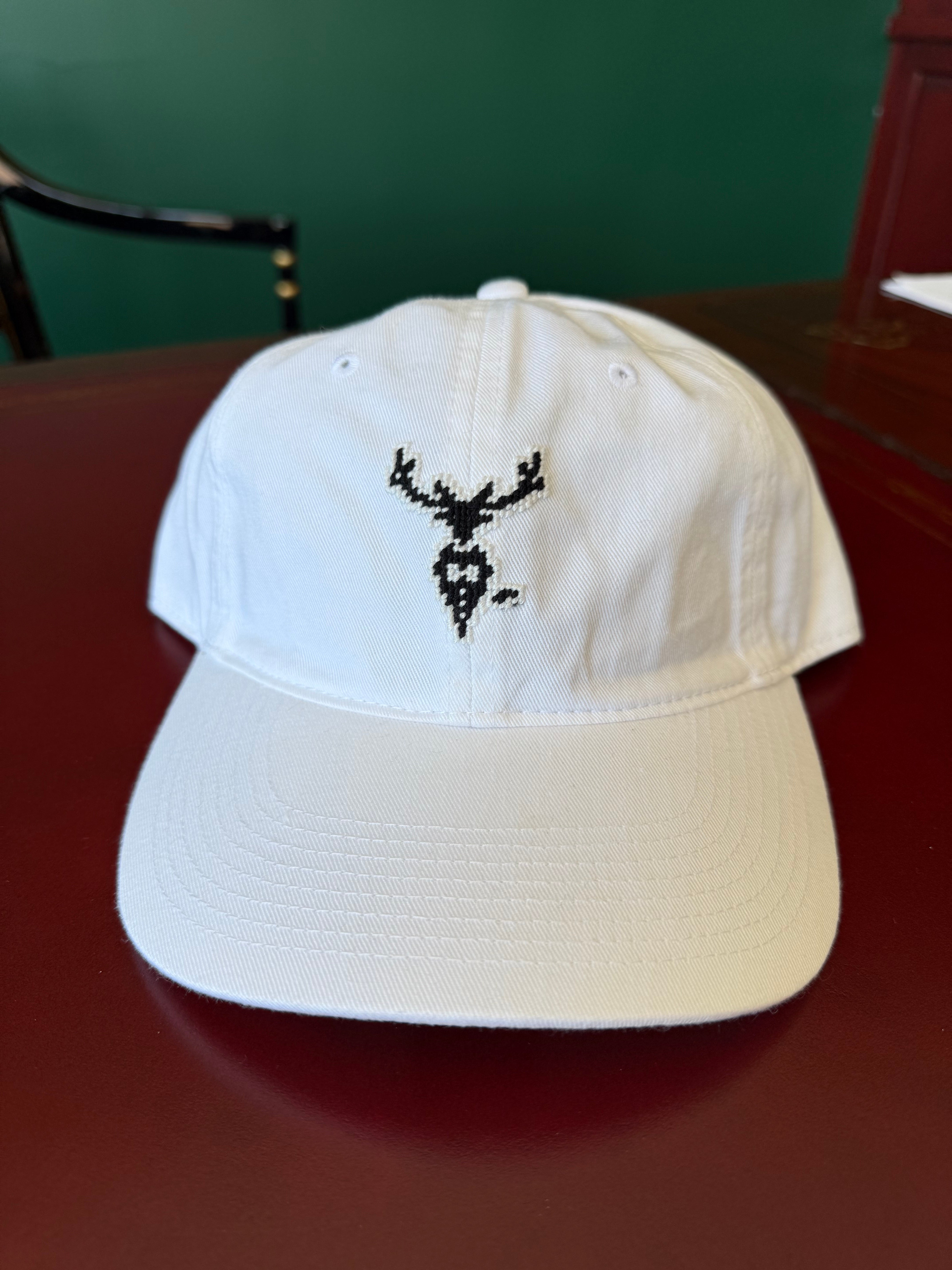 White cotton twill baseball cap with needlepoint Waring Tuxedos Fort Worth logo by Smathers & Branson